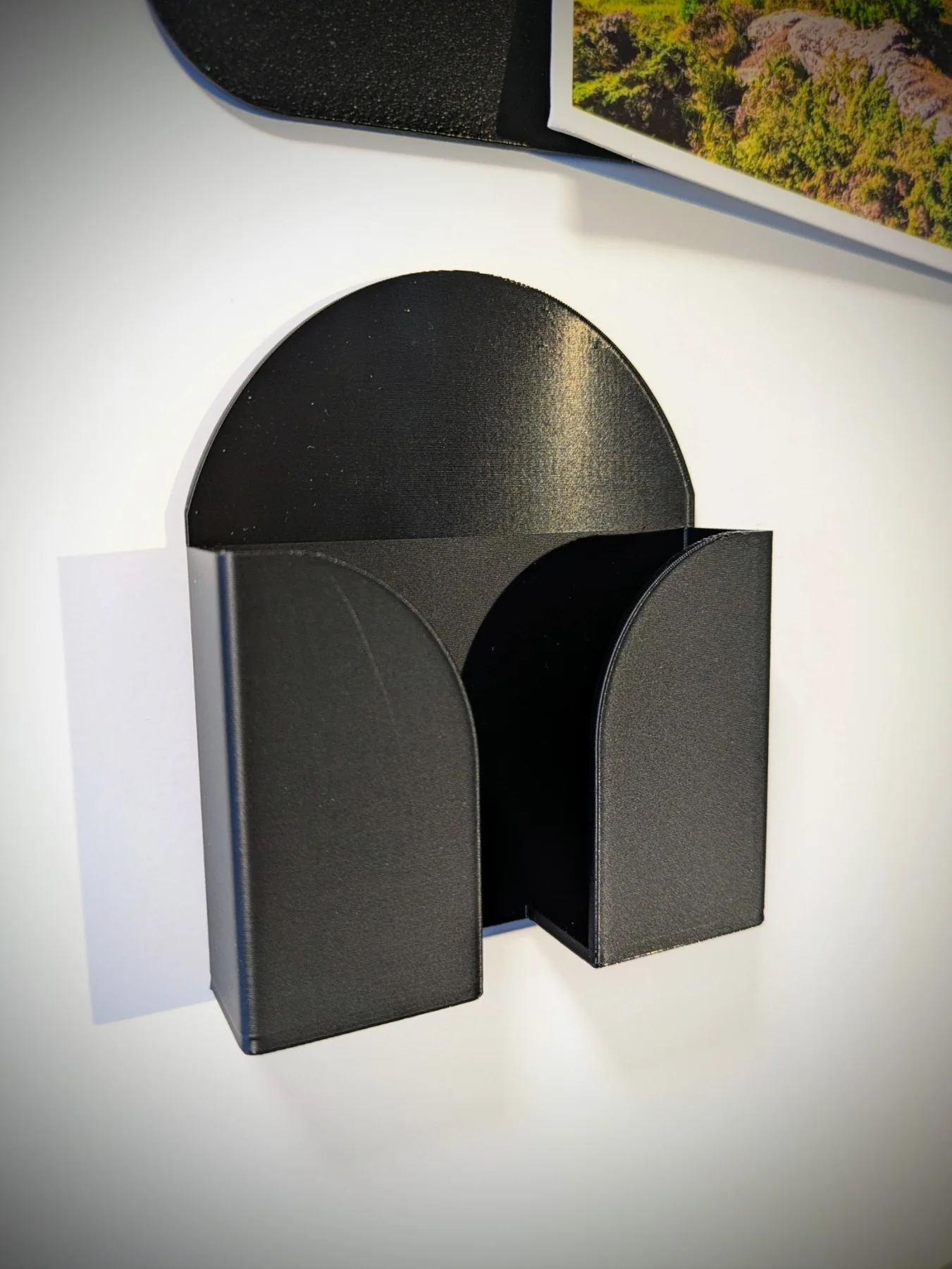 Détail du support mural noir pour téléphone en impression 3D
